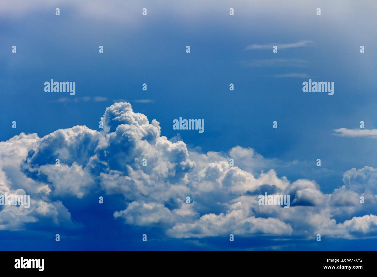 Cumulus clouds against a blue sky Stock Photo - Alamy