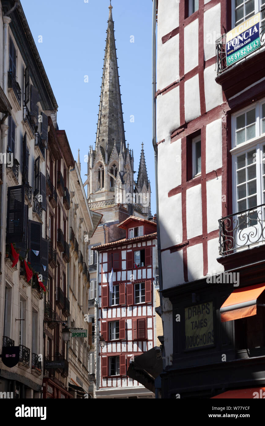 The view of one of the two steeples of the cathedral from the heart of  the old town of Bayonne.  Au coeur de la vieille ville de Bayonne. Stock Photo