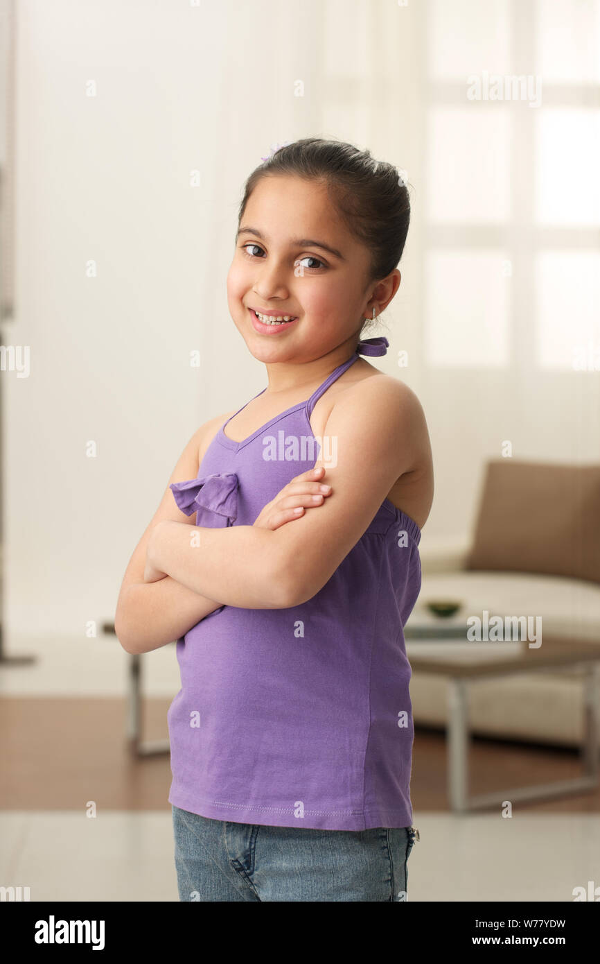 Girl smiling with arms crossed Stock Photo - Alamy