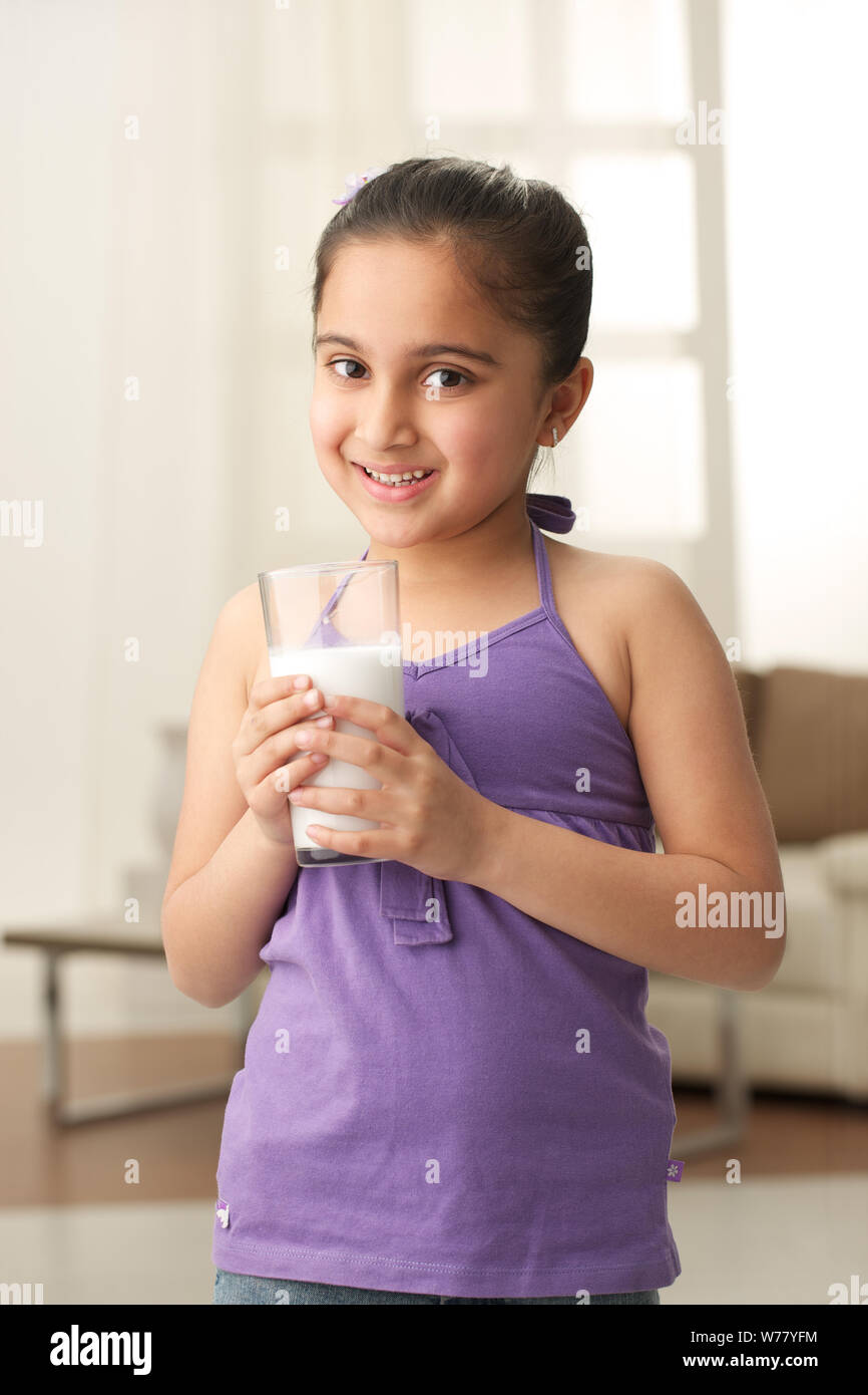 Girl drinking glass of milk Stock Photo Alamy