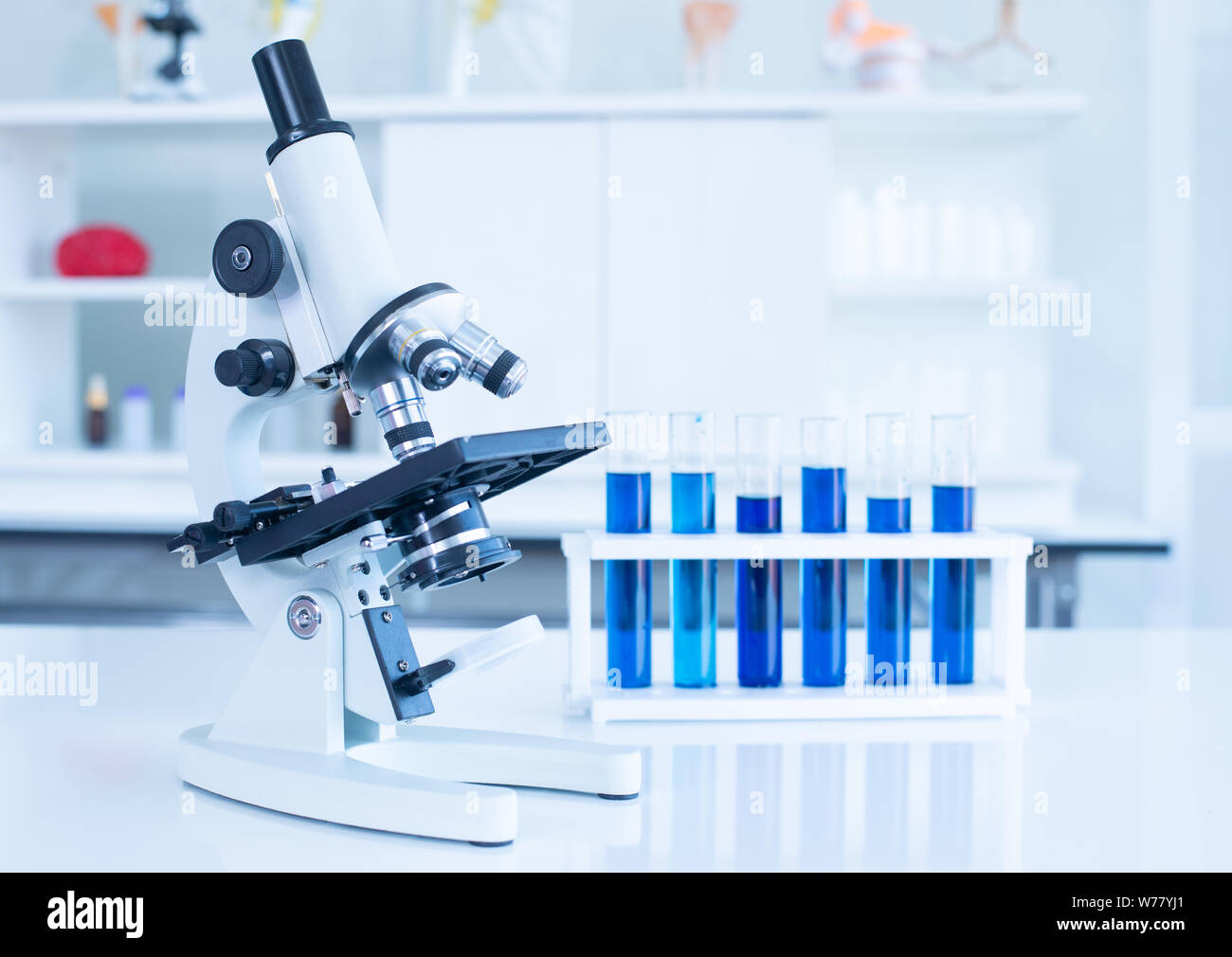 Microscope and glass tube in research laboratory concept. Stock Photo