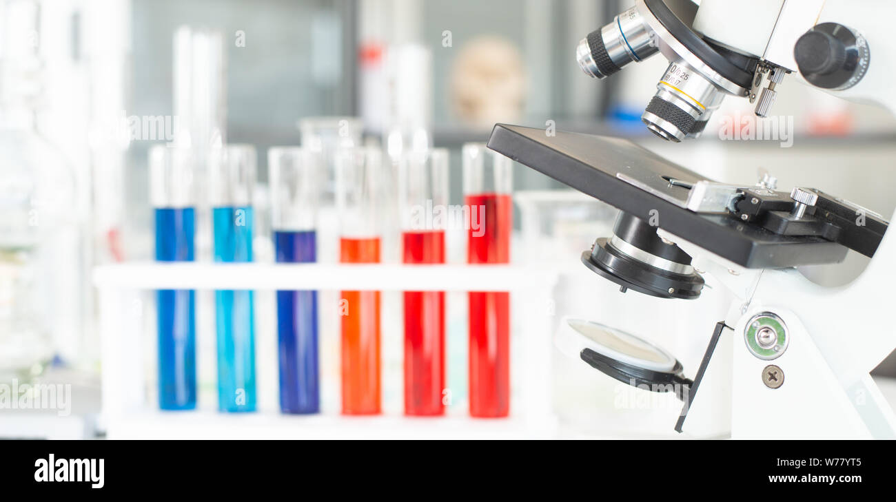 Microscope and glass tube in research laboratory concept. Stock Photo