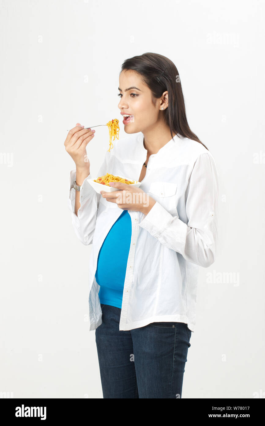 Pregnant woman eating noodles Stock Photo