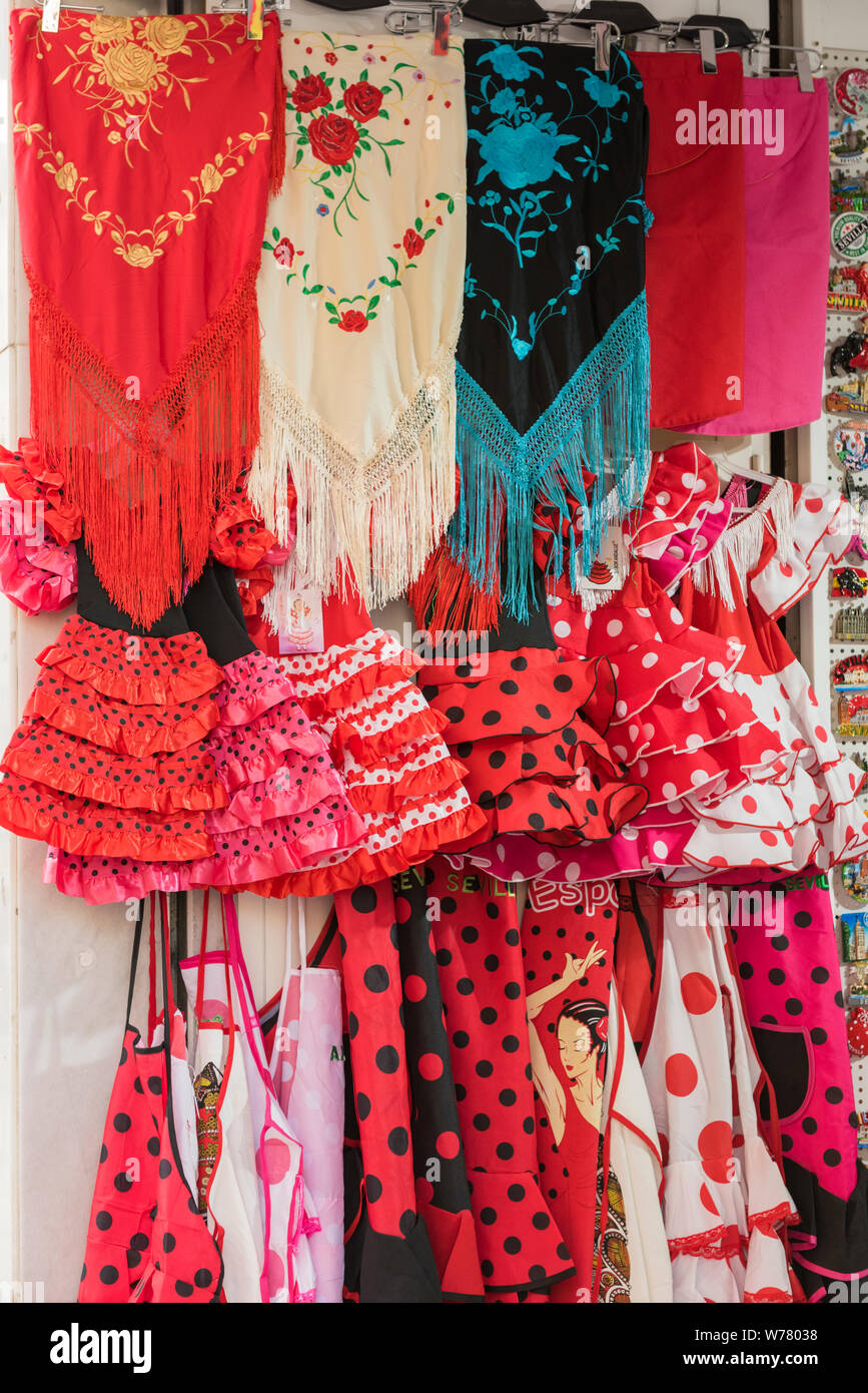 Brightly coloured red, black and blue flamenco style Spanish scarves and dresses for sale in Seville Spain Stock Photo