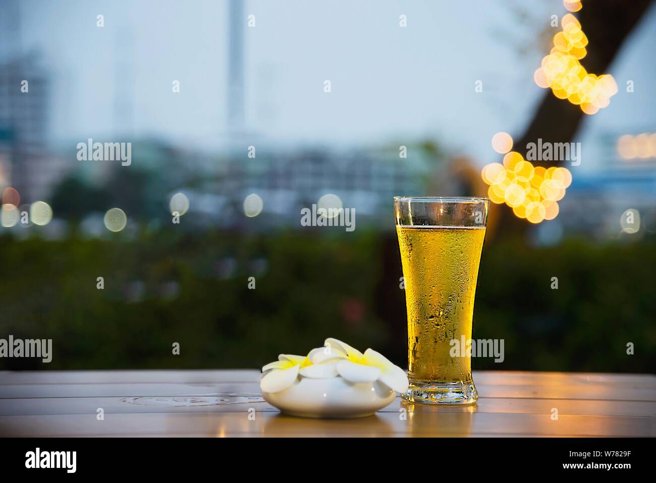 Cool beer glass in twilight - relax with beer in garden concept Stock Photo