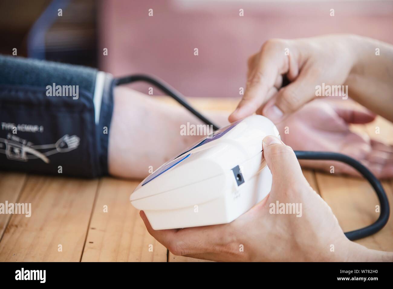 Old lady is being checked blood pressure using blood pressure monitor kid set - people with health care medical instrument set concept Stock Photo