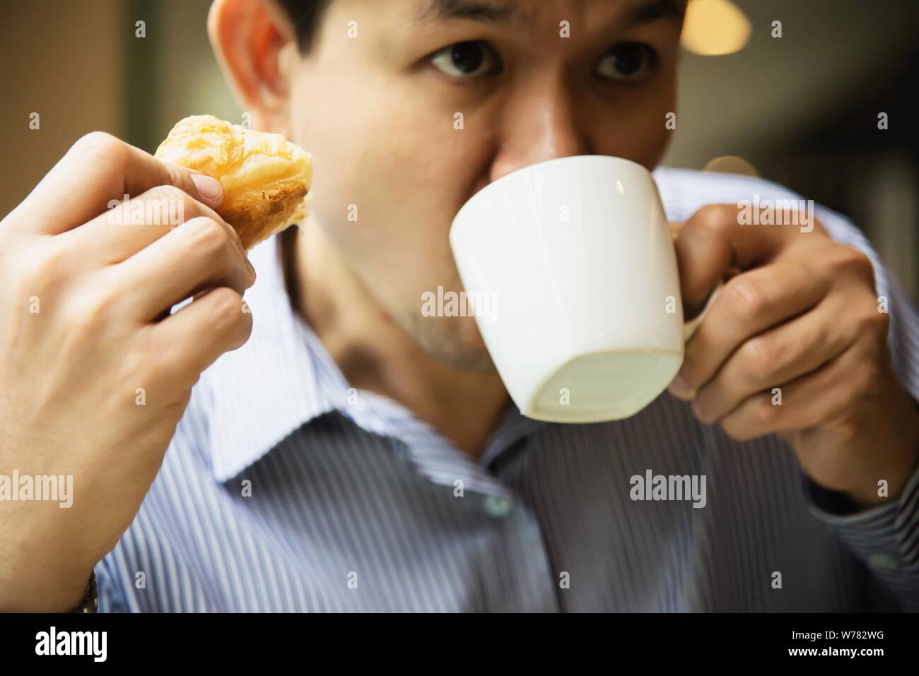 Business man eat the American breakfast set in a hotel - people take a breakfast in hotel concept Stock Photo