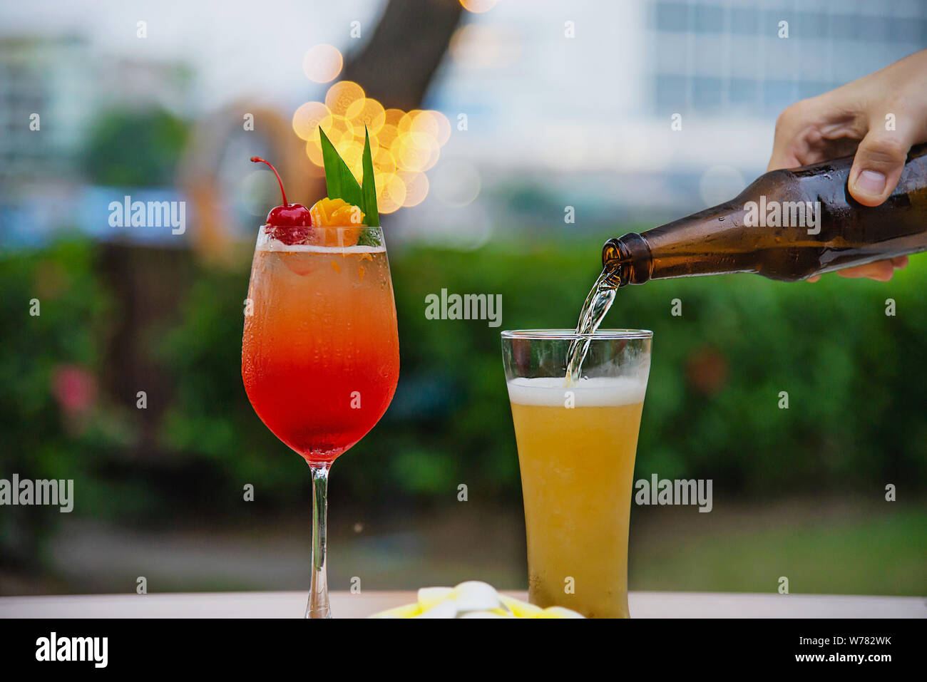 People celebration in restaurant with beer and mai tai or mai thai - happy lifestyle people with happy drink in garden concept Stock Photo