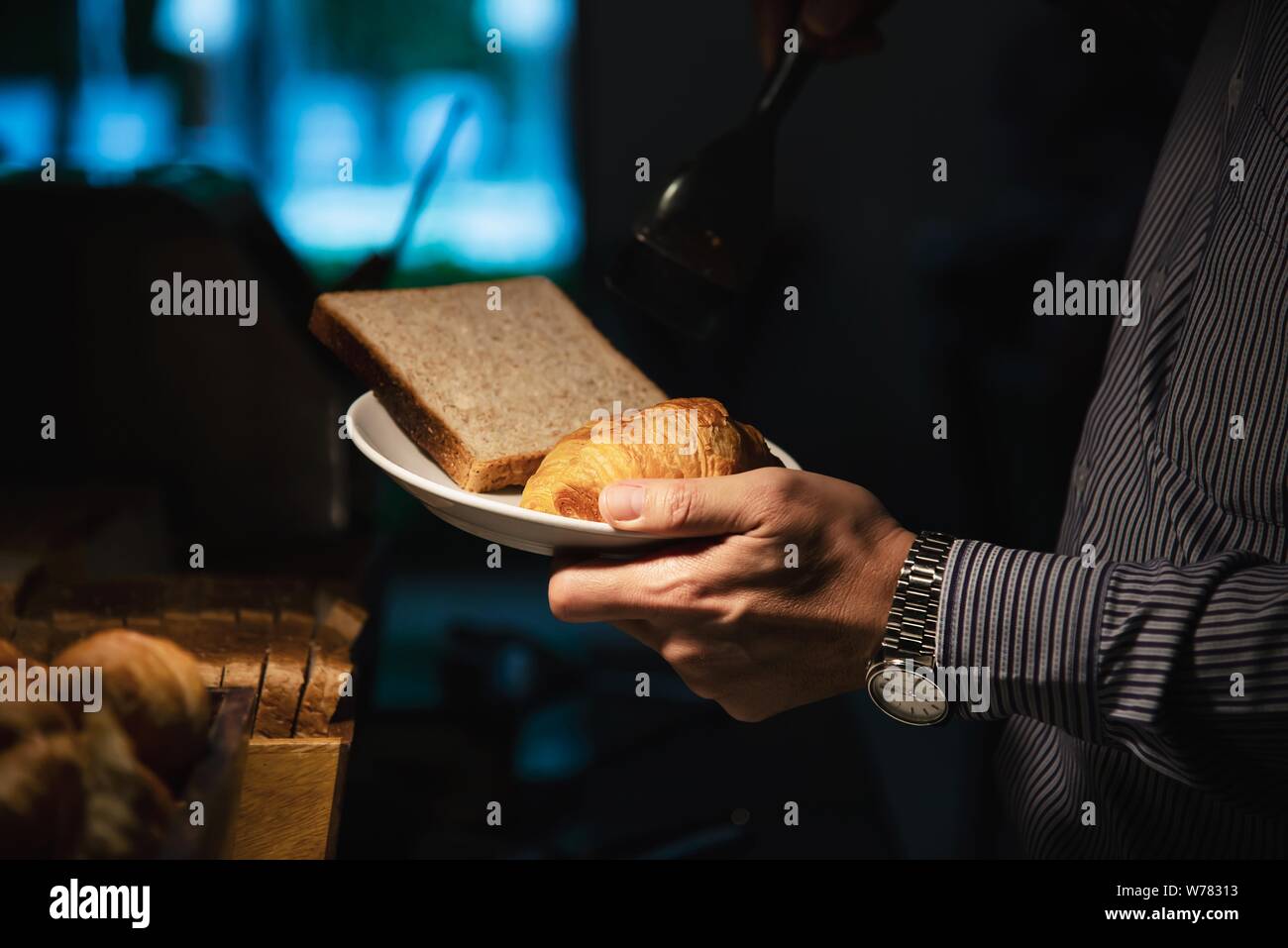 Business man eat the American breakfast set in a hotel - people take a breakfast in hotel concept Stock Photo