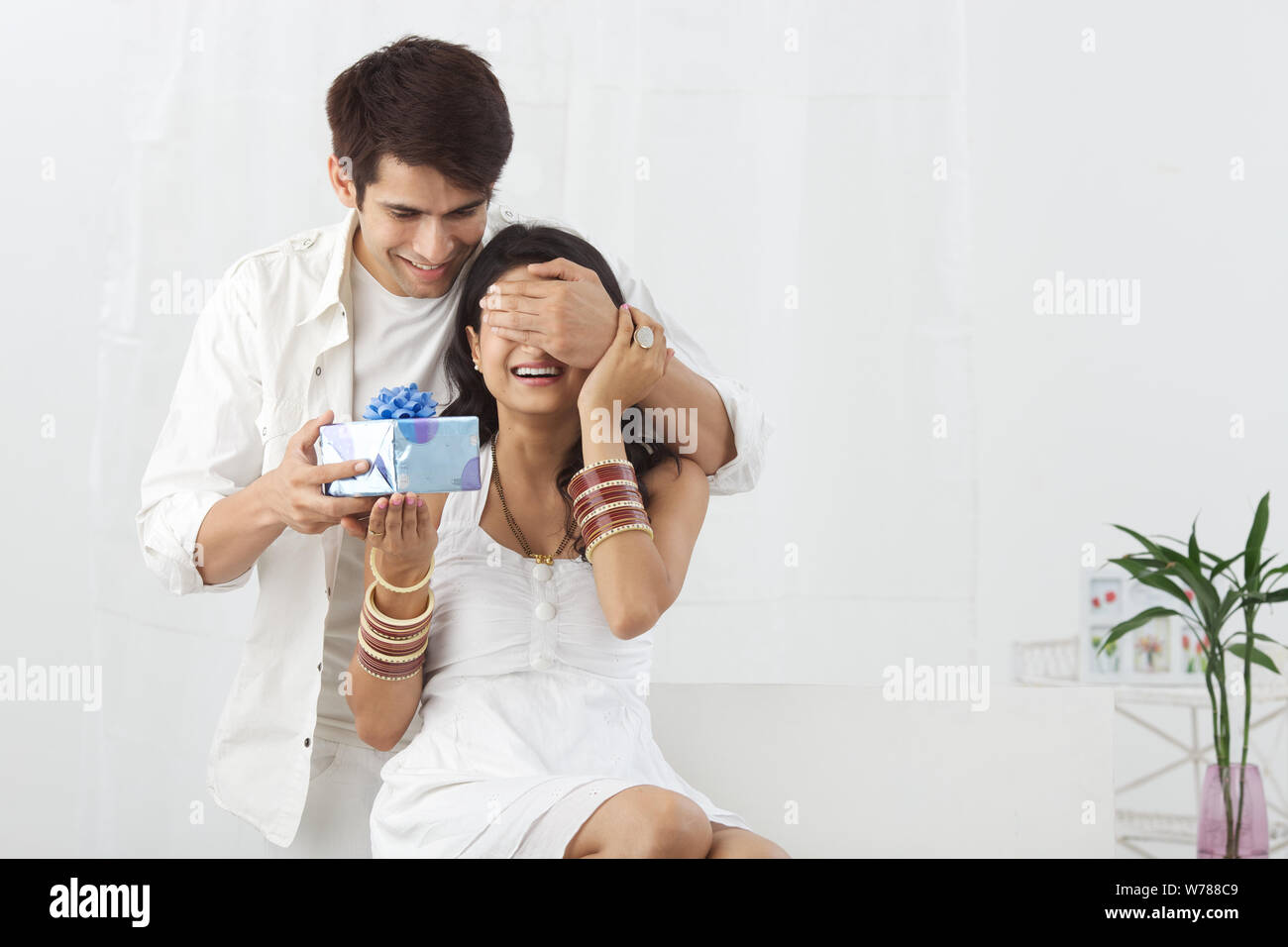 Young man giving a gift to his wife Stock Photo Alamy