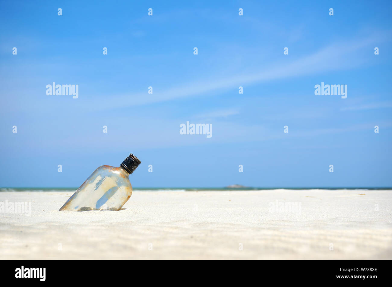 Bottle on a sand beach Stock Photo - Alamy
