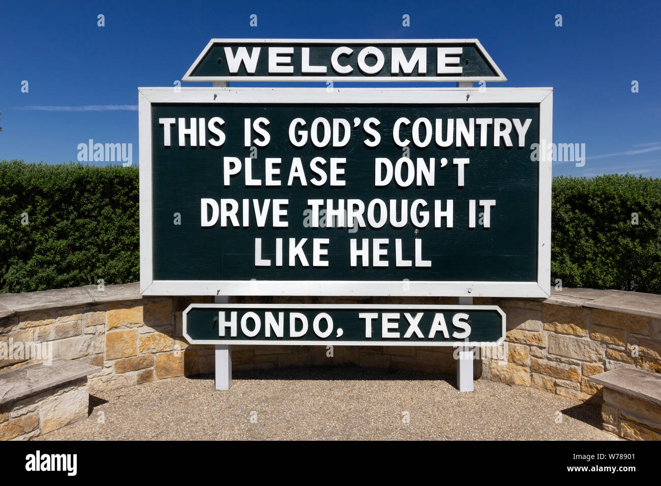 Road sign, Hondo: ‘This Is God’s Country. Please Don’t Drive Through It Like Hell’ Stock Photo