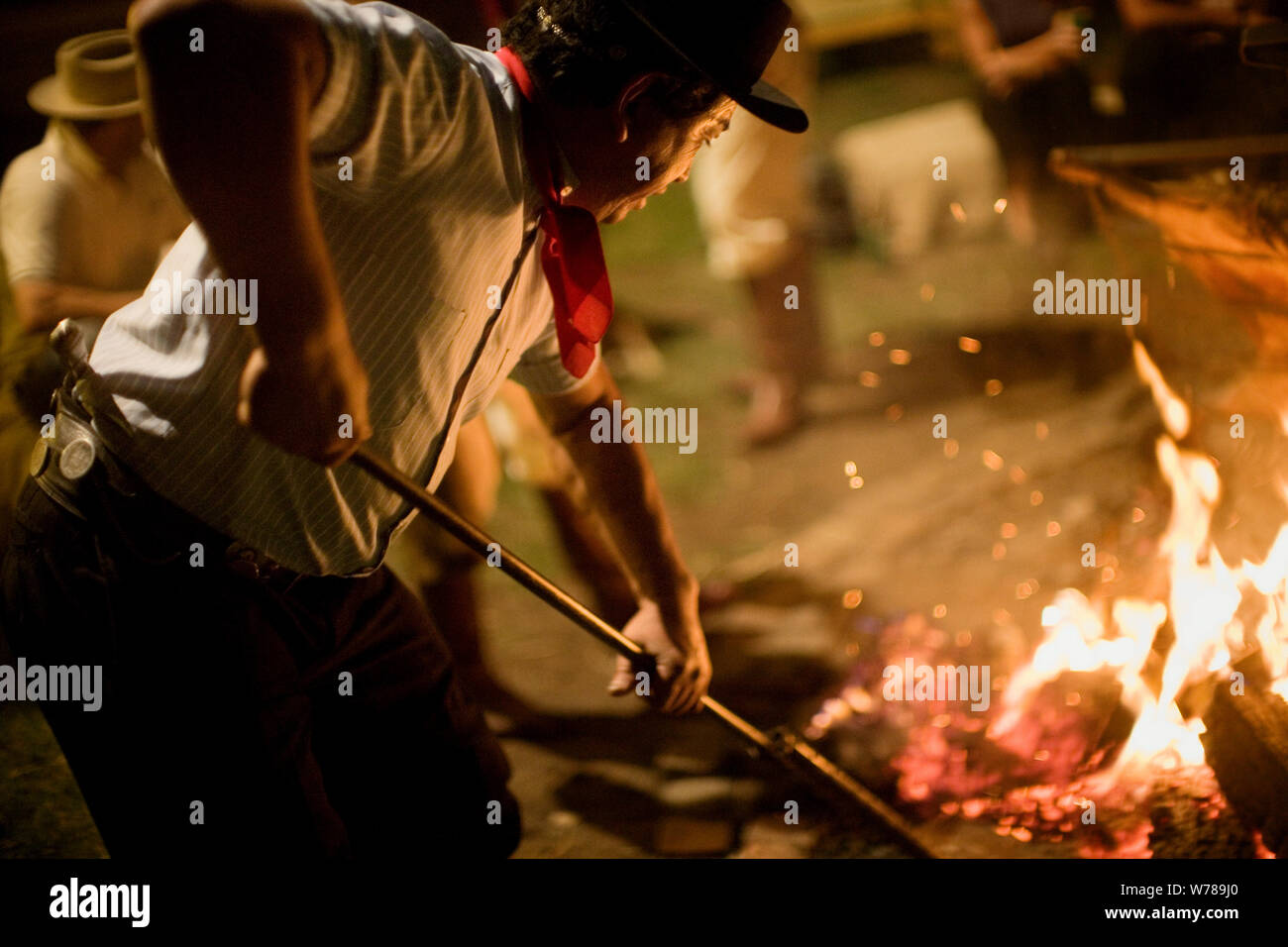 Man stoking a fire hires stock photography and images Alamy