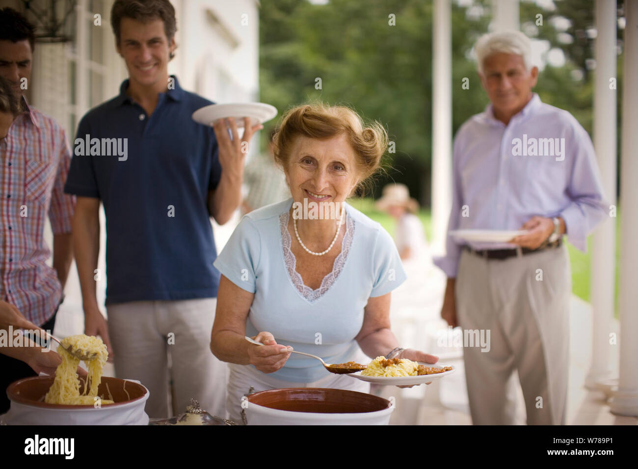 View of a family gathered for a buffet Stock Photo - Alamy