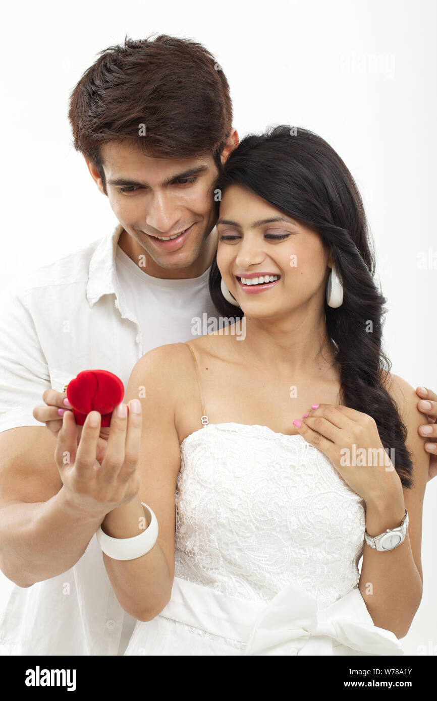 Young man giving an engagement ring to a woman Stock Photo Alamy