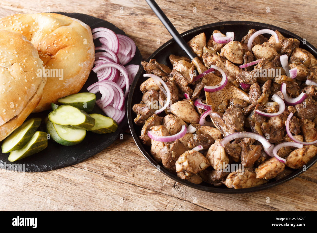 Jewish traditional food meorav Yerushalmi from chicken and offal close-up on a plate on the table. horizontal Stock Photo