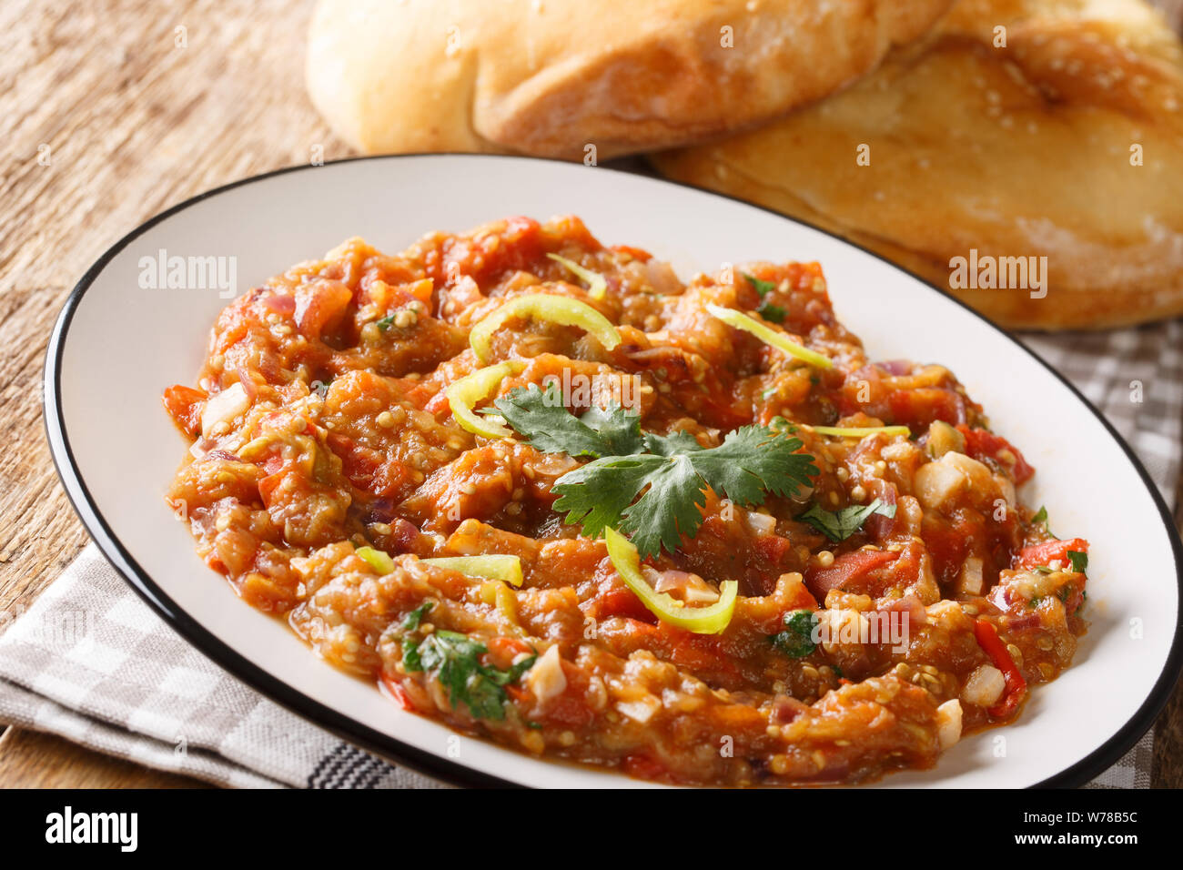 baingan bharta recipe, roasted eggplant curry closeup on the plate on the table. horizontal Stock Photo