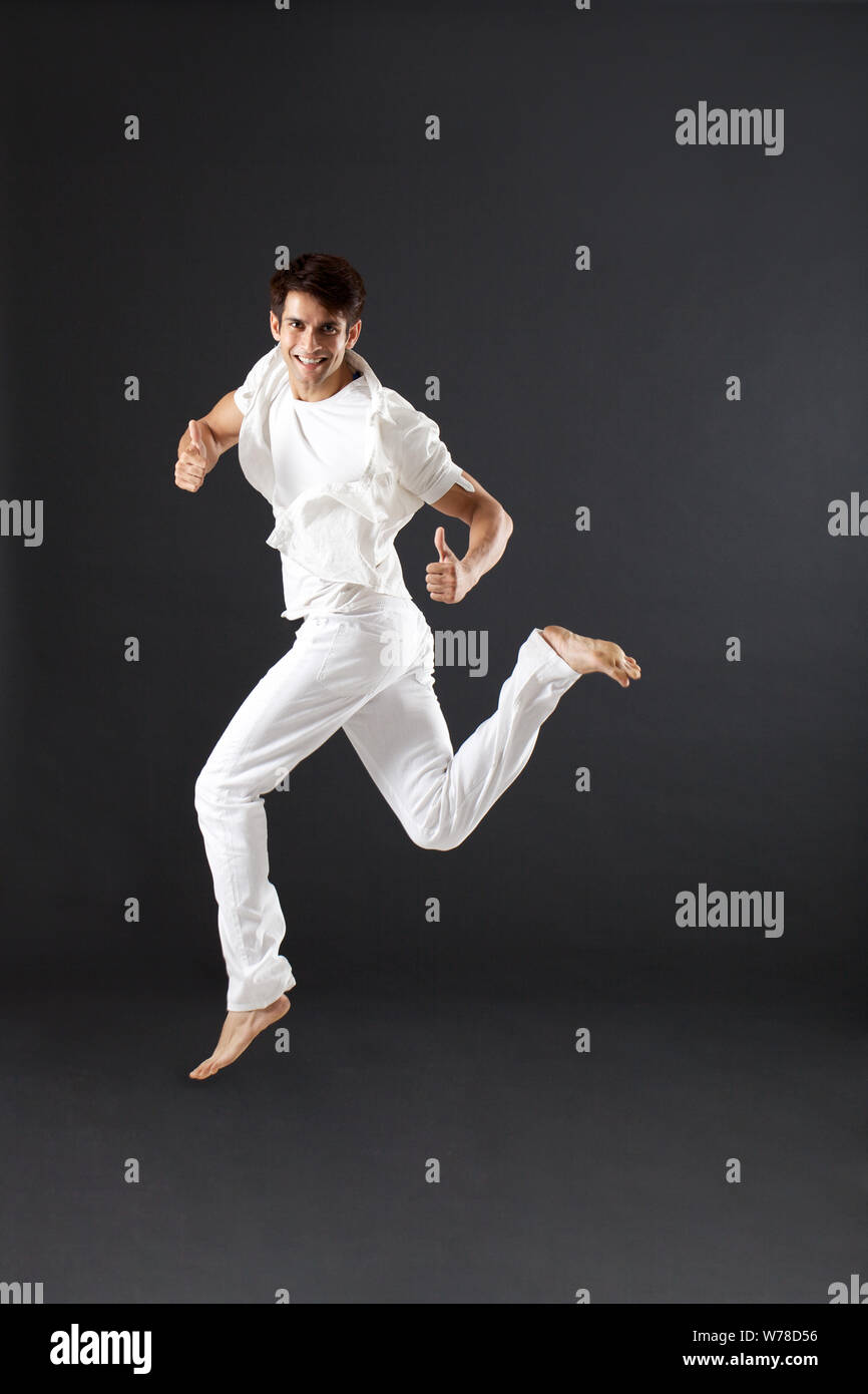Young man jumping in mid air Stock Photo