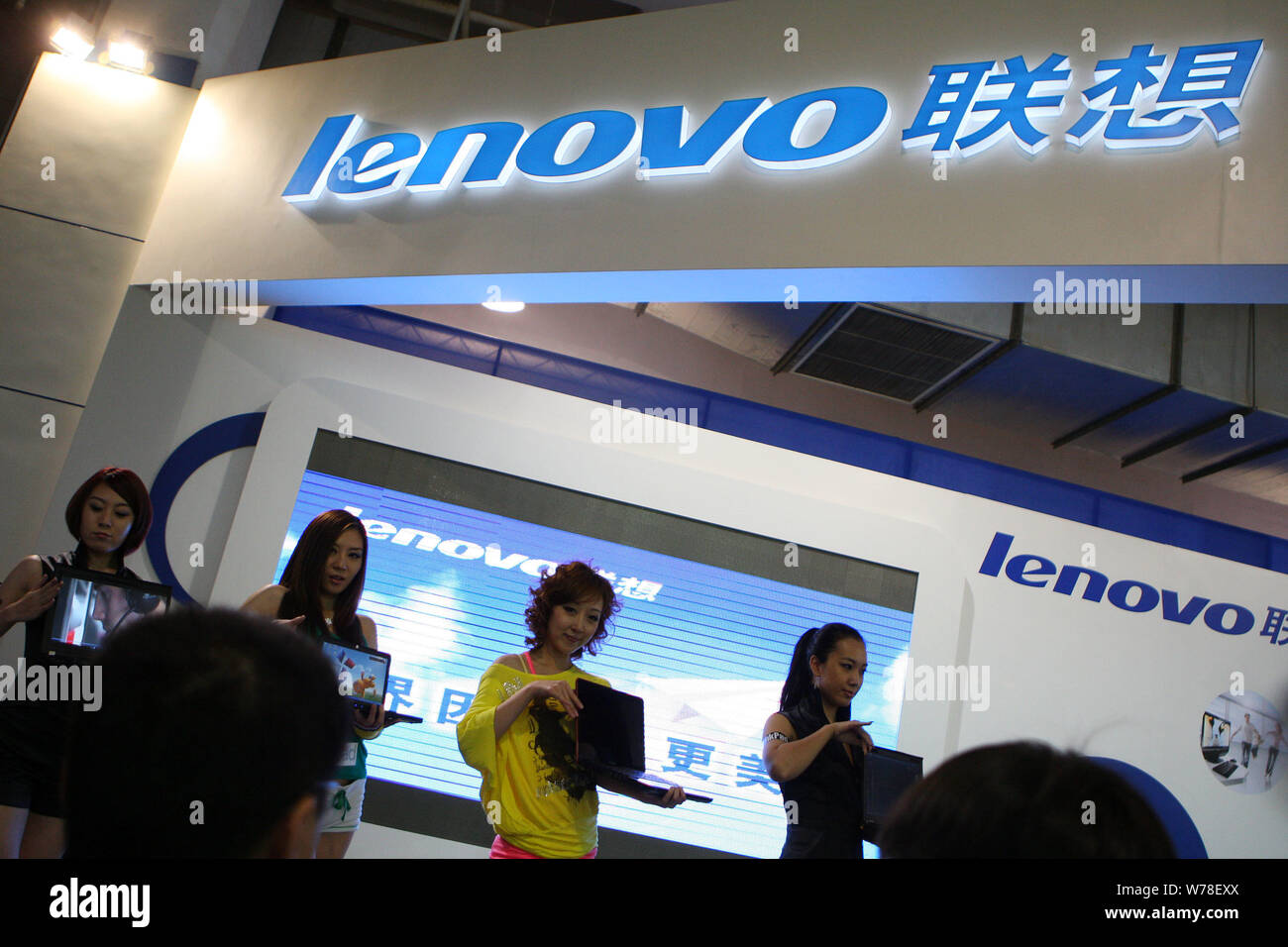 Chines Computer --FILE--Chinese models display laptop computers of Lenovo at the 12th ...