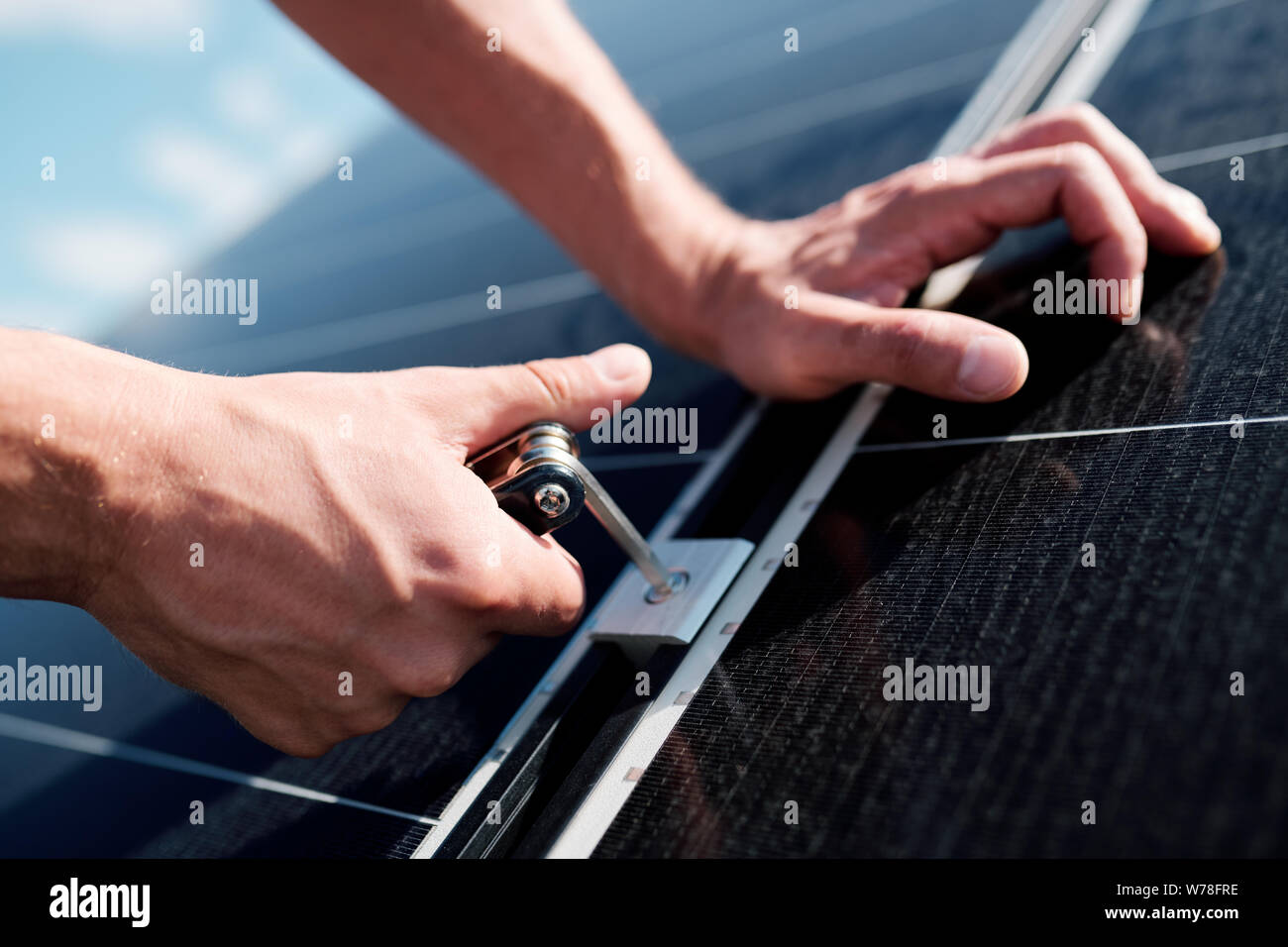 Hands of professional technician or engineer installing solar panels Stock Photo