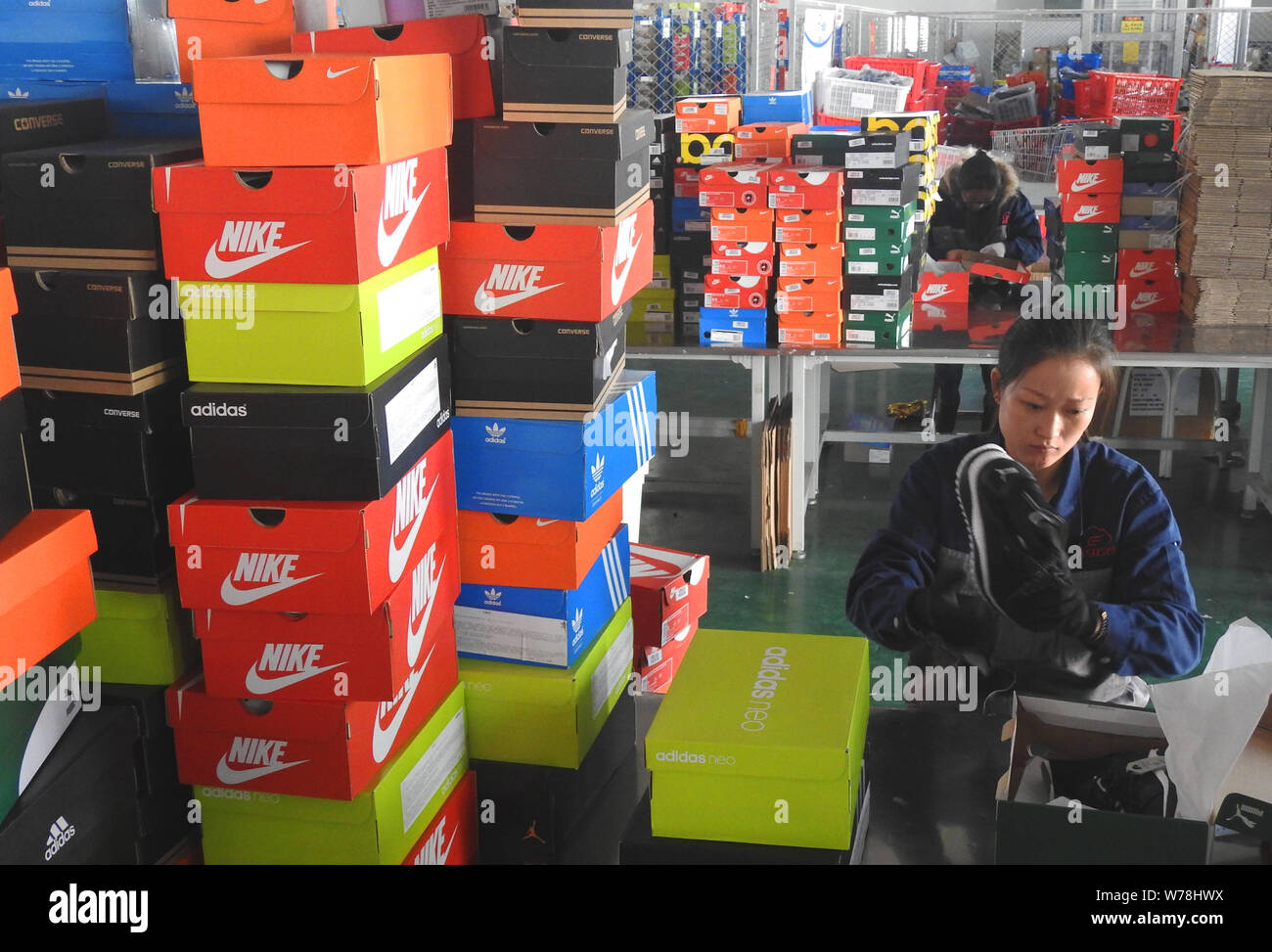 A Chinese worker prepares the shoes for the upcoming 11.11 global shopping  festival of Alibaba group at a warehouse in Lianyungang city, east China's  Stock Photo - Alamy