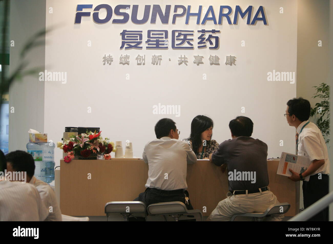 --FILE--People visit the stand of Fosun Pharma of Fosun Group during an exhibition in Shanghai, China, 1 February 2011.   Shanghai Fosun Pharmaceutica Stock Photo