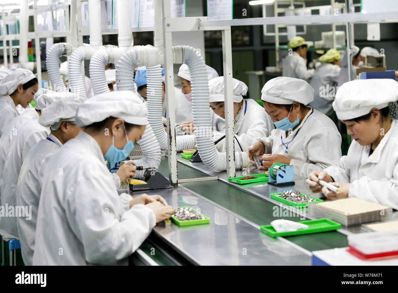 triathlon petal Regularly FILE--Female Chinese workers produce mobile phone parts on the assembly line  at a factory in Huaibei city, east China's Anhui province, 7 March 2017  Stock Photo - Alamy