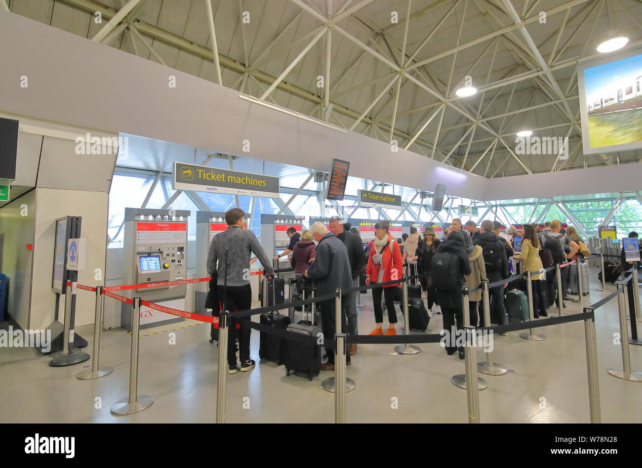 People queue to buy Gatwick Express train ticket at Gatwick airport London  England Stock Photo - Alamy