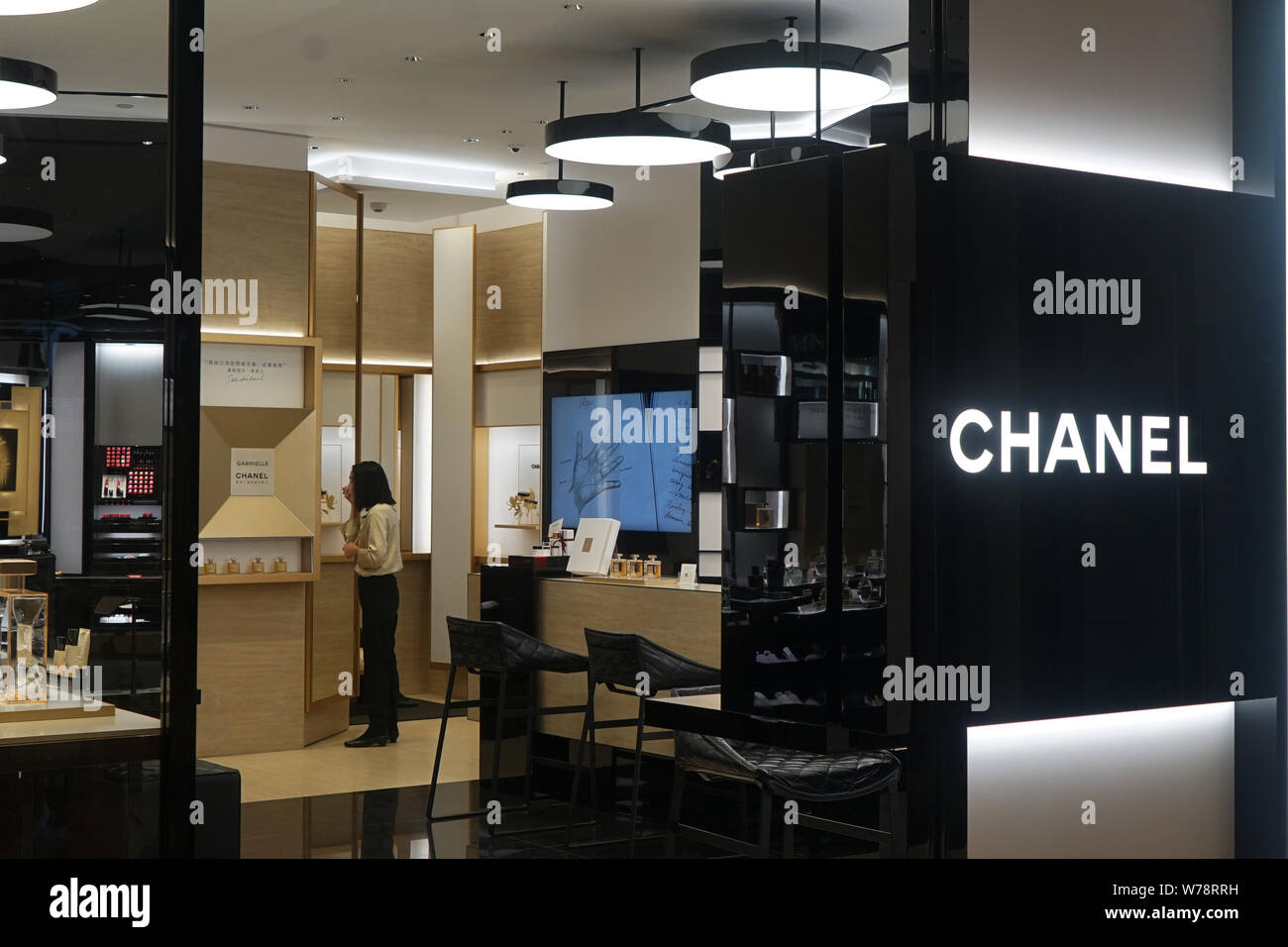 FILE--A Chinese employee is seen at a boutique of luxury brand Chanel in  Shanghai, China, 30 August 2017. The 2017 Worldwide Luxury Market Monitor  Stock Photo - Alamy