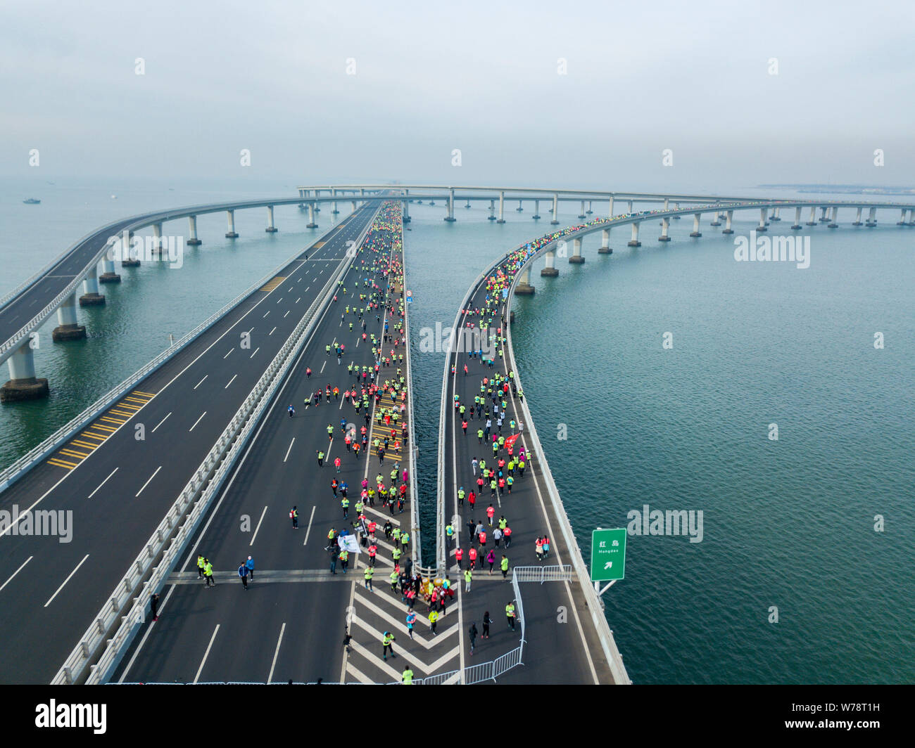 Participants compete in the world's first marathon on the sea on Jiaozhou Bay Bridge (or Qingdao ...