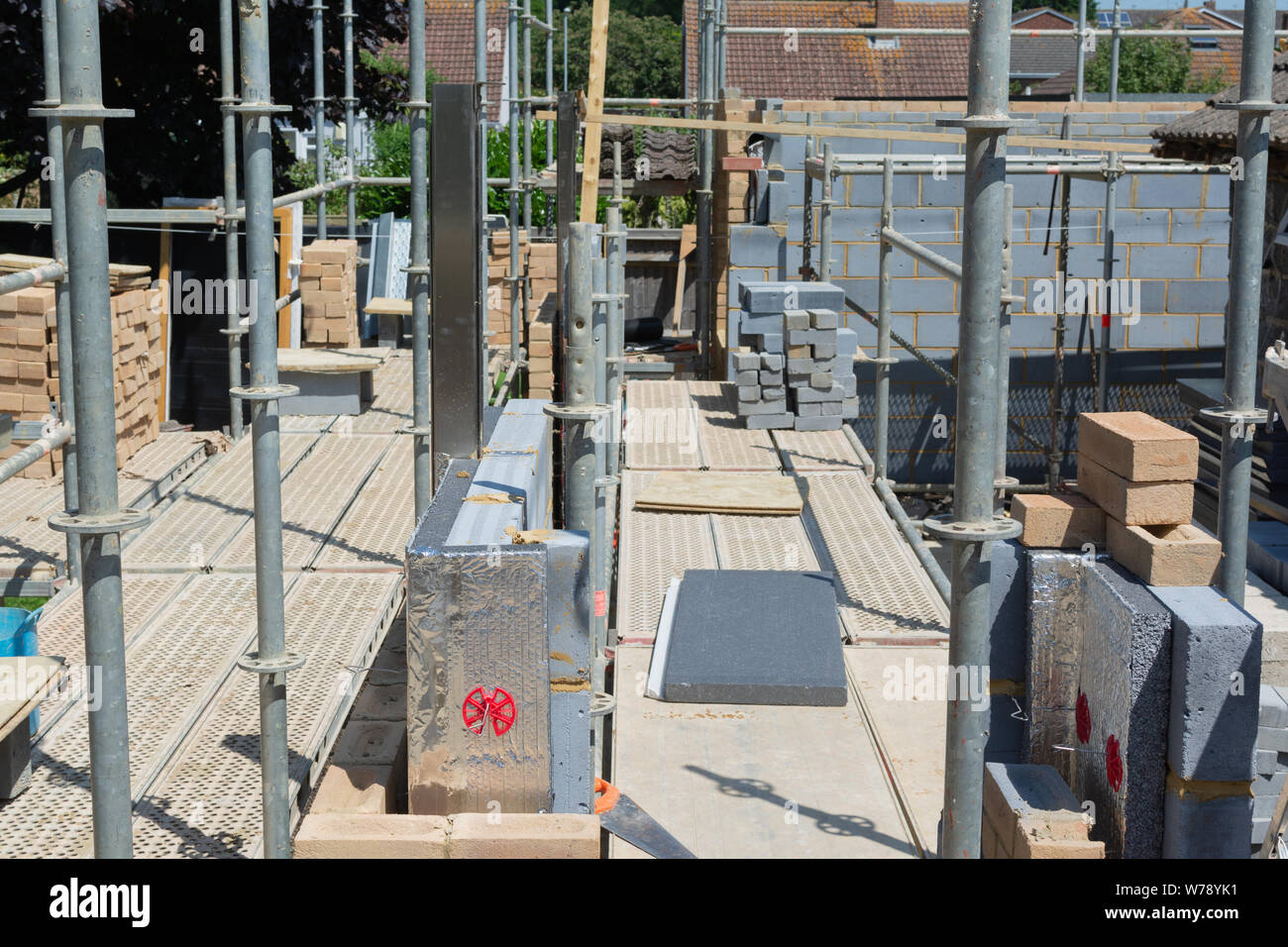 Renovation projects. Building of extension of the existing house, unfinished brick walls, block