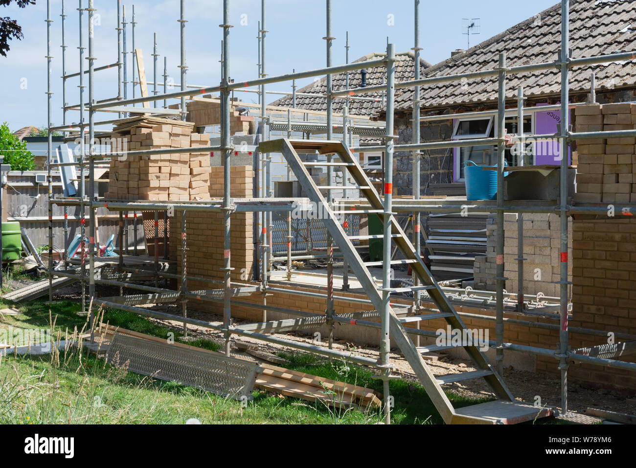 Renovation projects. Building of extension of the existing house, unfinished brick walls, block