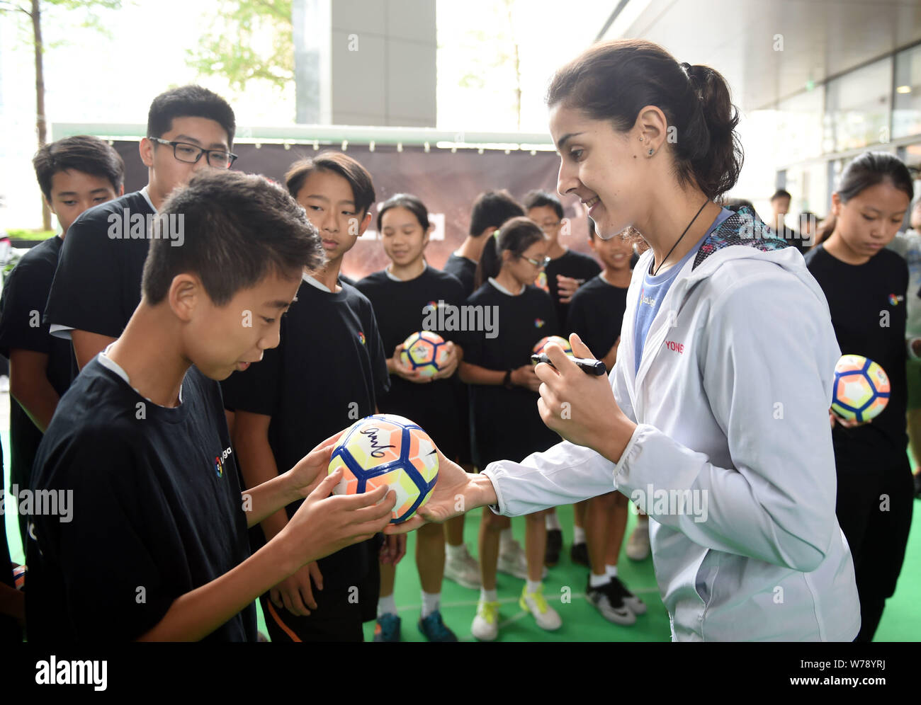 Spanish badminton champion Carolina Marin, signs autographys for young local footballl players during an event to promote La Liga, the Spanish footbal Stock Photo