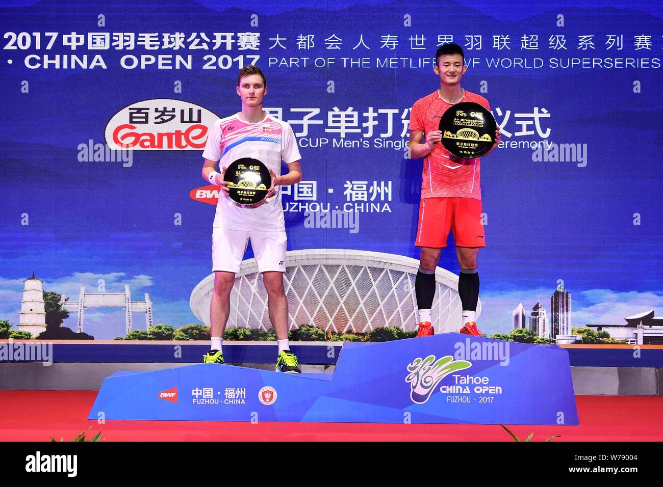 Winner Chen Long Of China Right And First Runner Up Viktor Axelsen Of Denmark Pose With Their Trophies At The Award Ceremony After Their Final Match Stock Photo Alamy