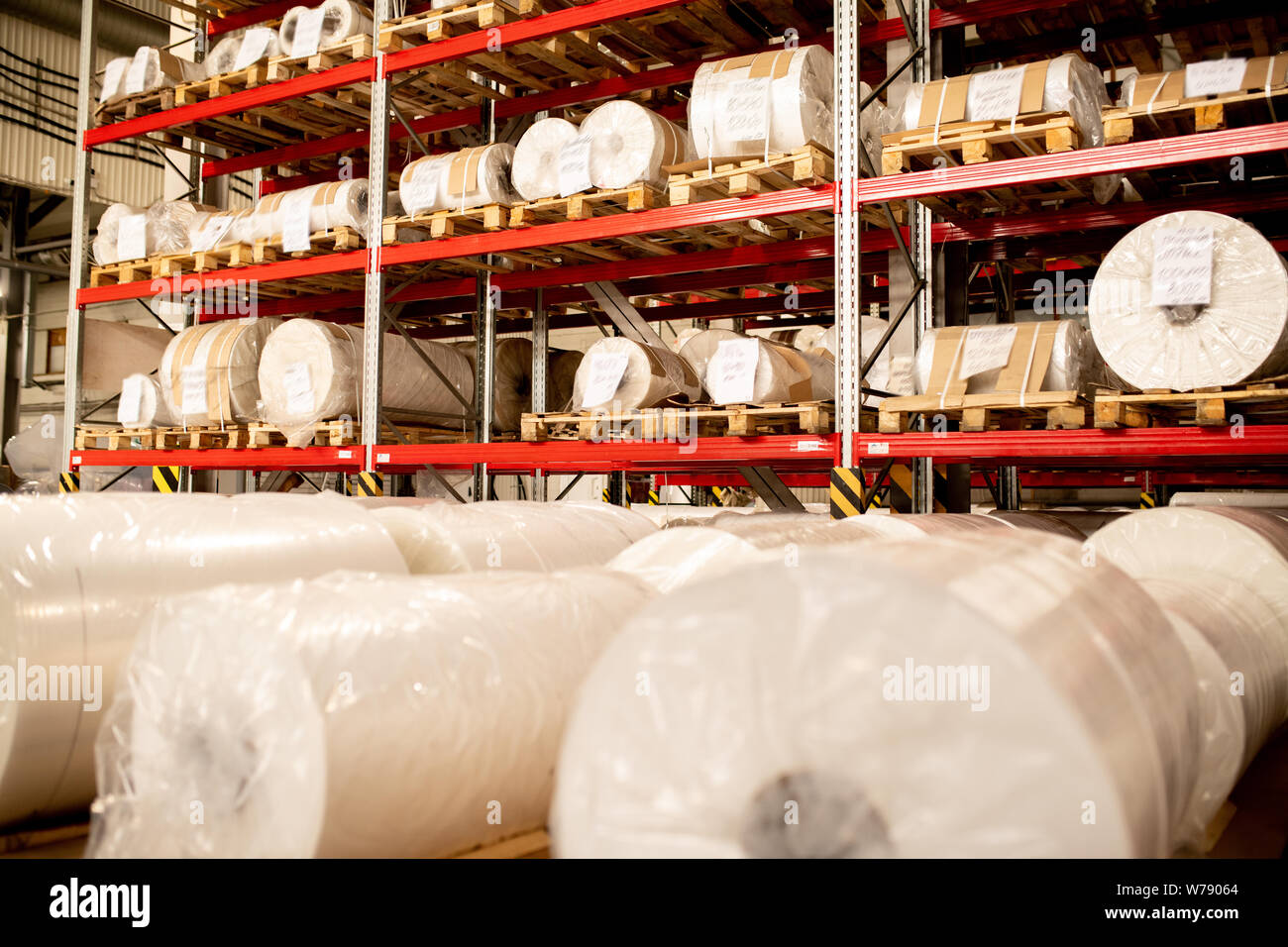 Rows of rolled and packed newly produced huge bobbins of polyethylene membrane Stock Photo