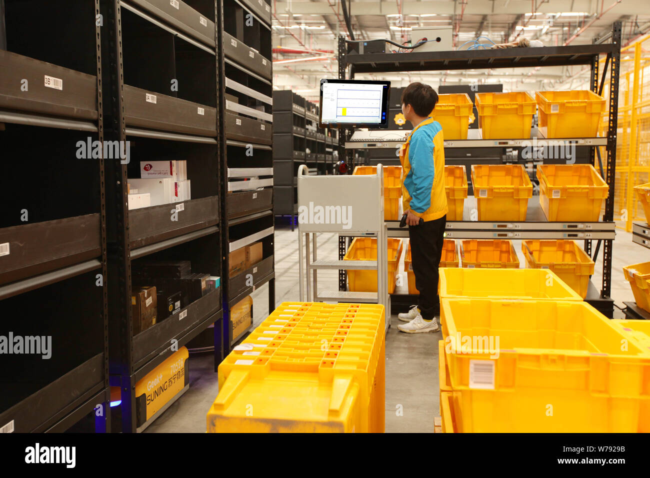 A Chinese worker sort out parcels in the electronics logistics base of