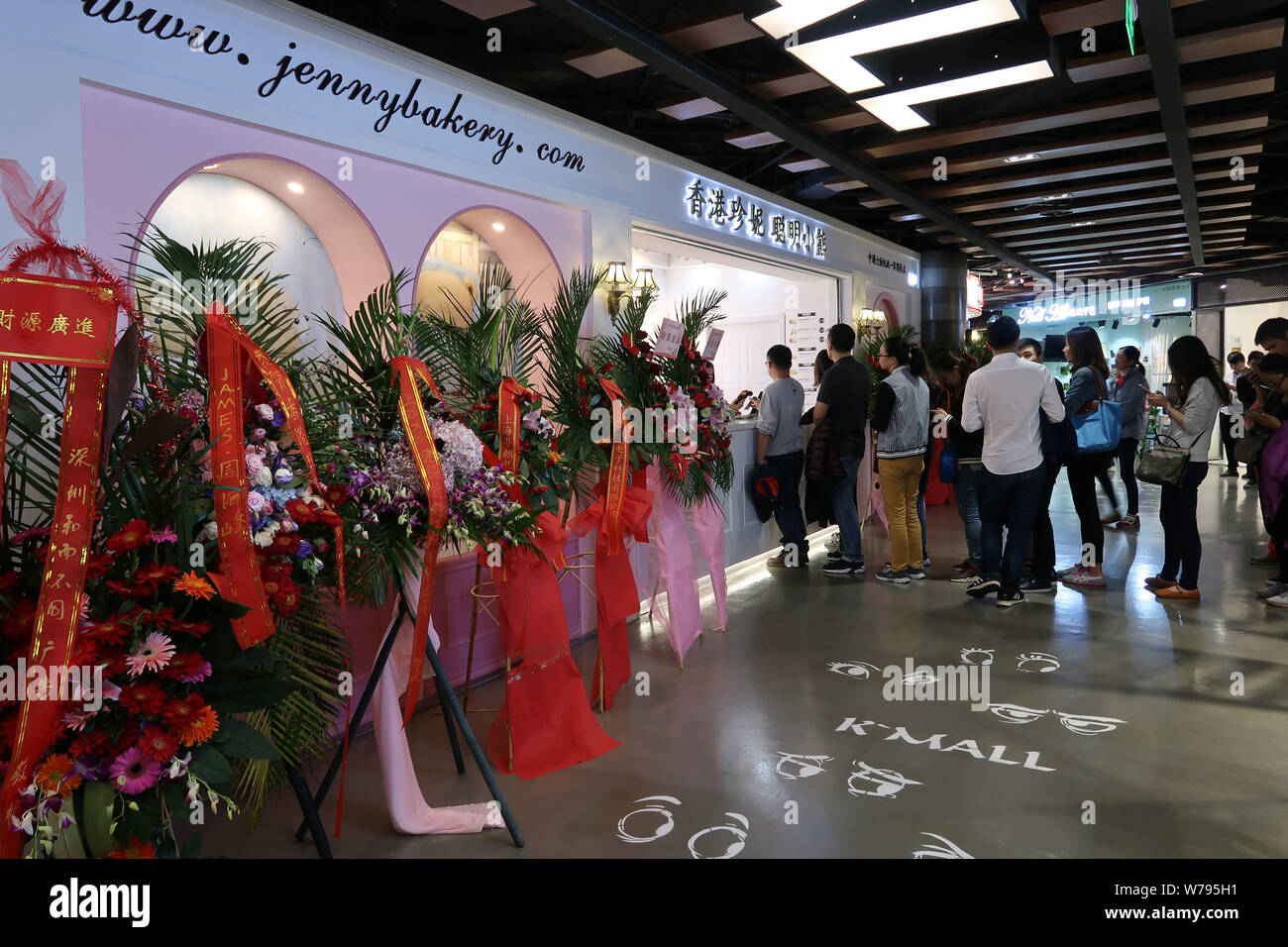 Chinese customers queue up to buy handmade butter cookies at the Jenny