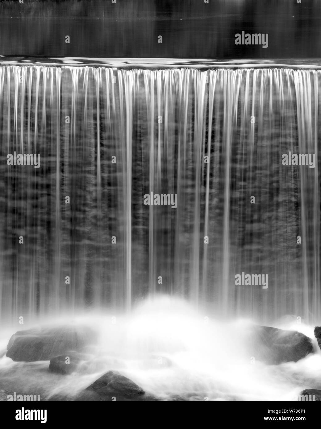 waterfall along the course of a river, with water falling like a veil