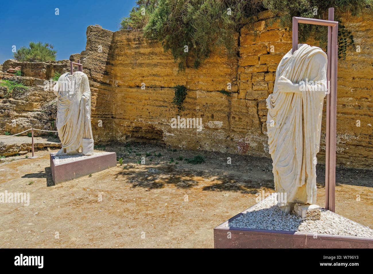 Headless Roman statues on display in archaeological site. Two torso