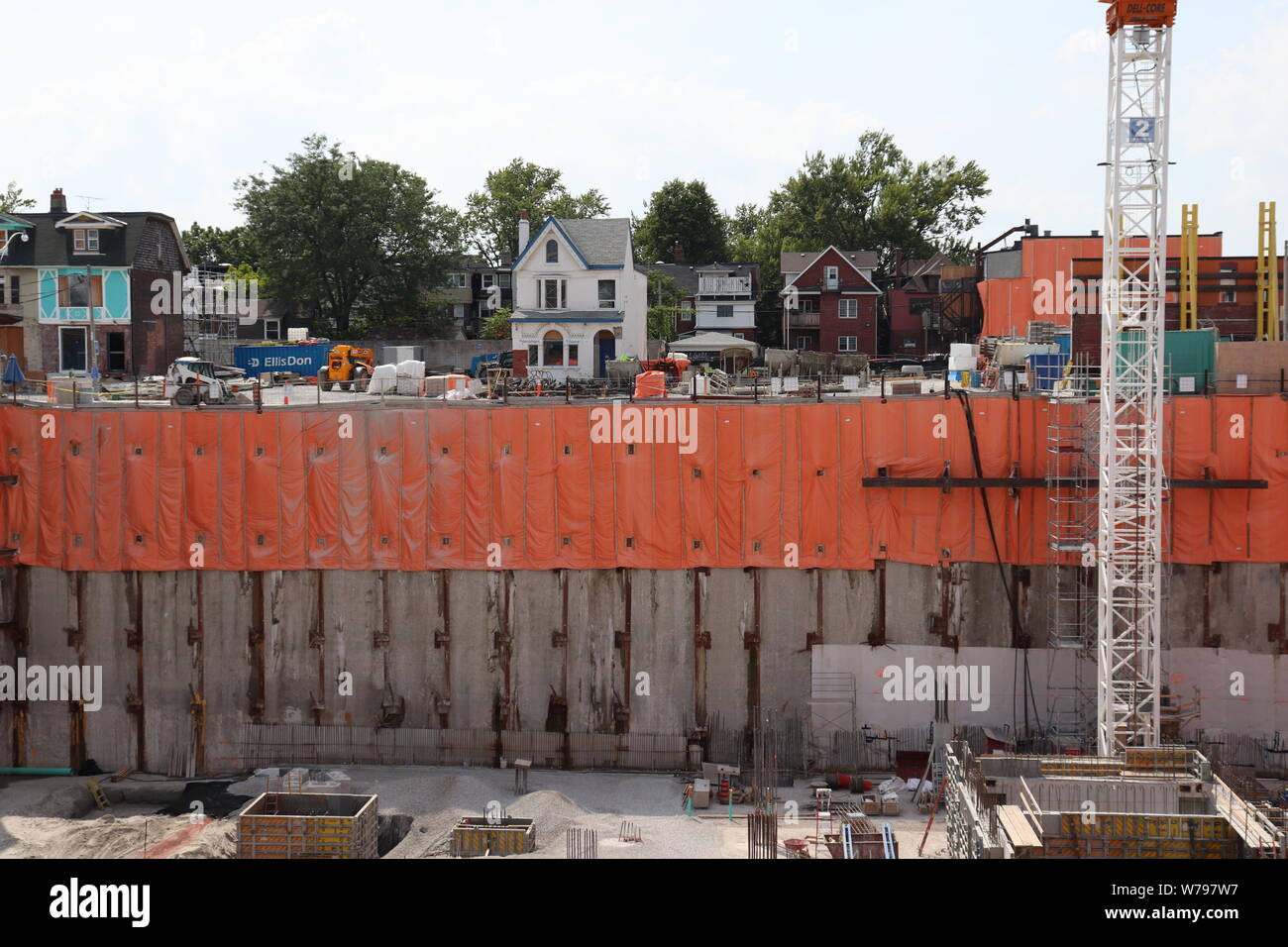 A row of houses sit above construction at the old Honest Ed's site in Toronto Stock Photo