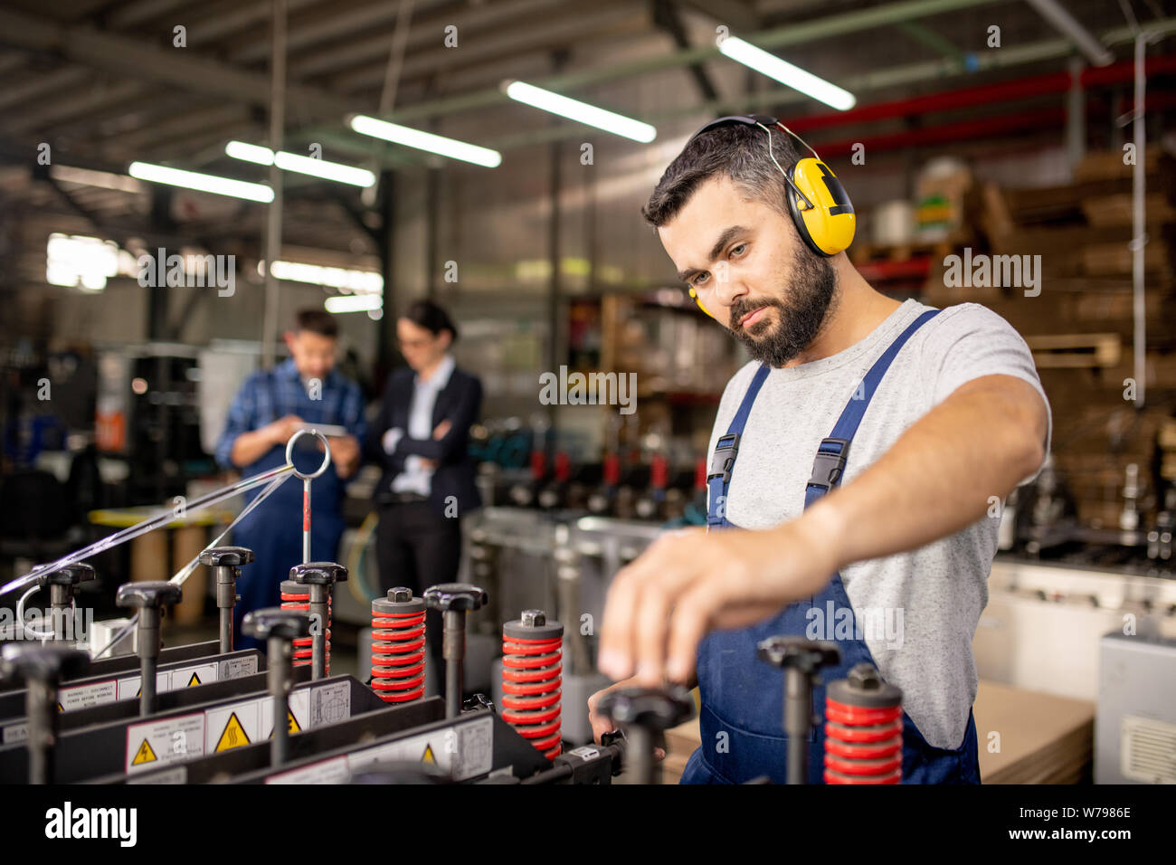 Serious technician of processing factory setting technical equipment