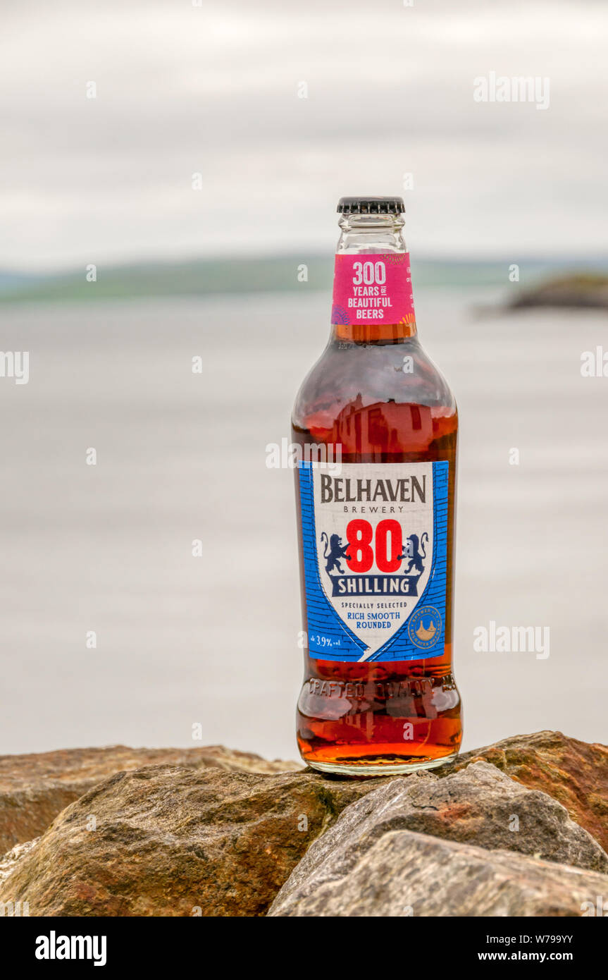 A bottle of Belhaven 80 Shilling beer photographed in the Scottish countryside.  Details in Description. Stock Photo