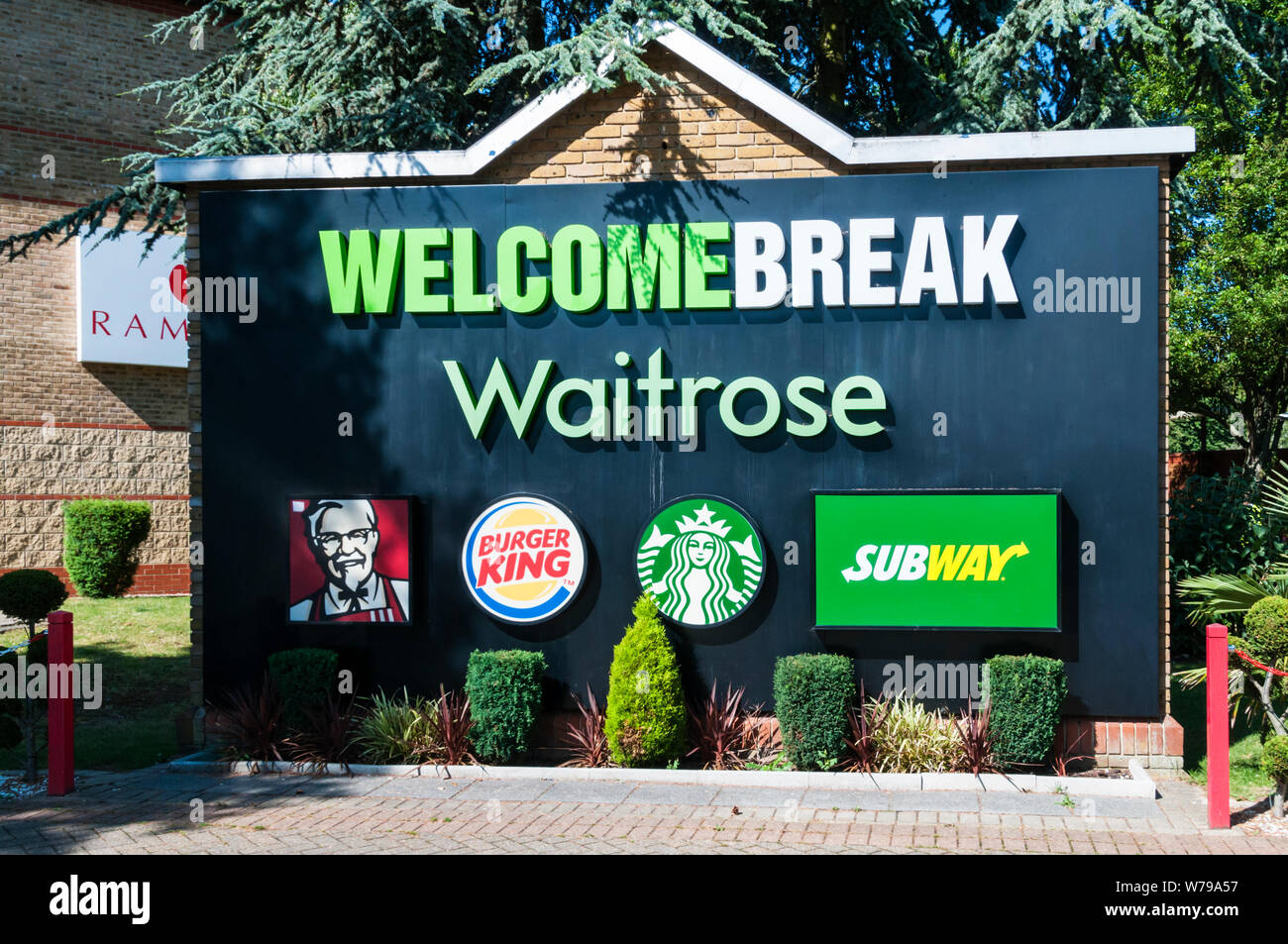 A Welcome Break sign at Birchanger motorway services on the M11 with trademarks of Waitrose, KFC, Burger King, Starbucks and Subway. Stock Photo