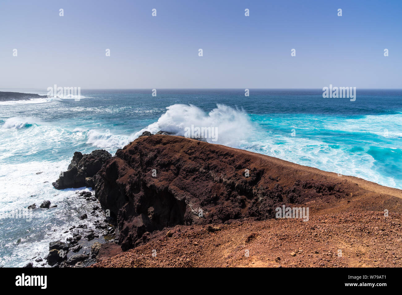 Spain, Lanzarote, Amazing strong waves breaking on rocks creating huge spume clouds Stock Photo