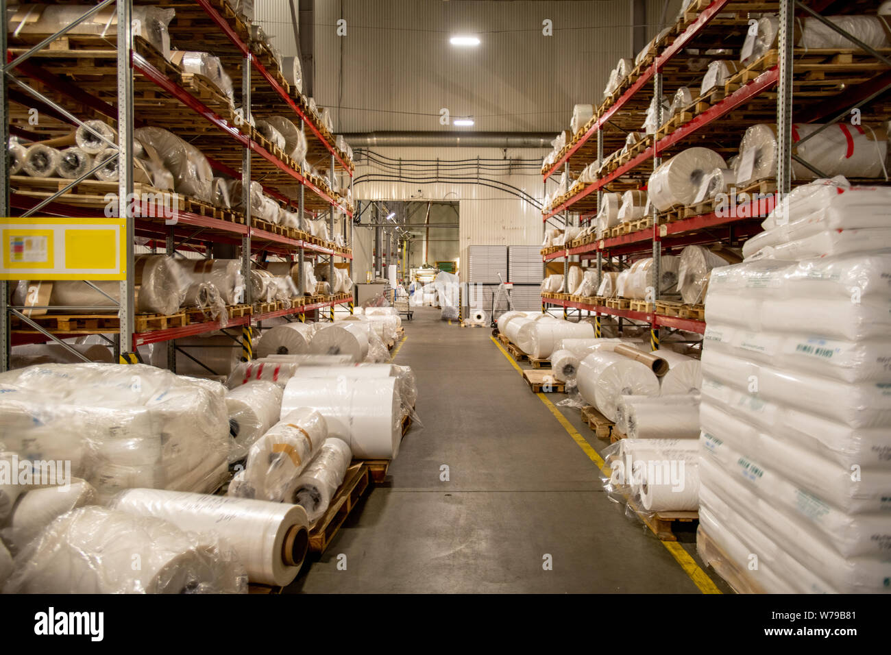 Warehouse of modern chemical production factory with rolled polyethylene film Stock Photo