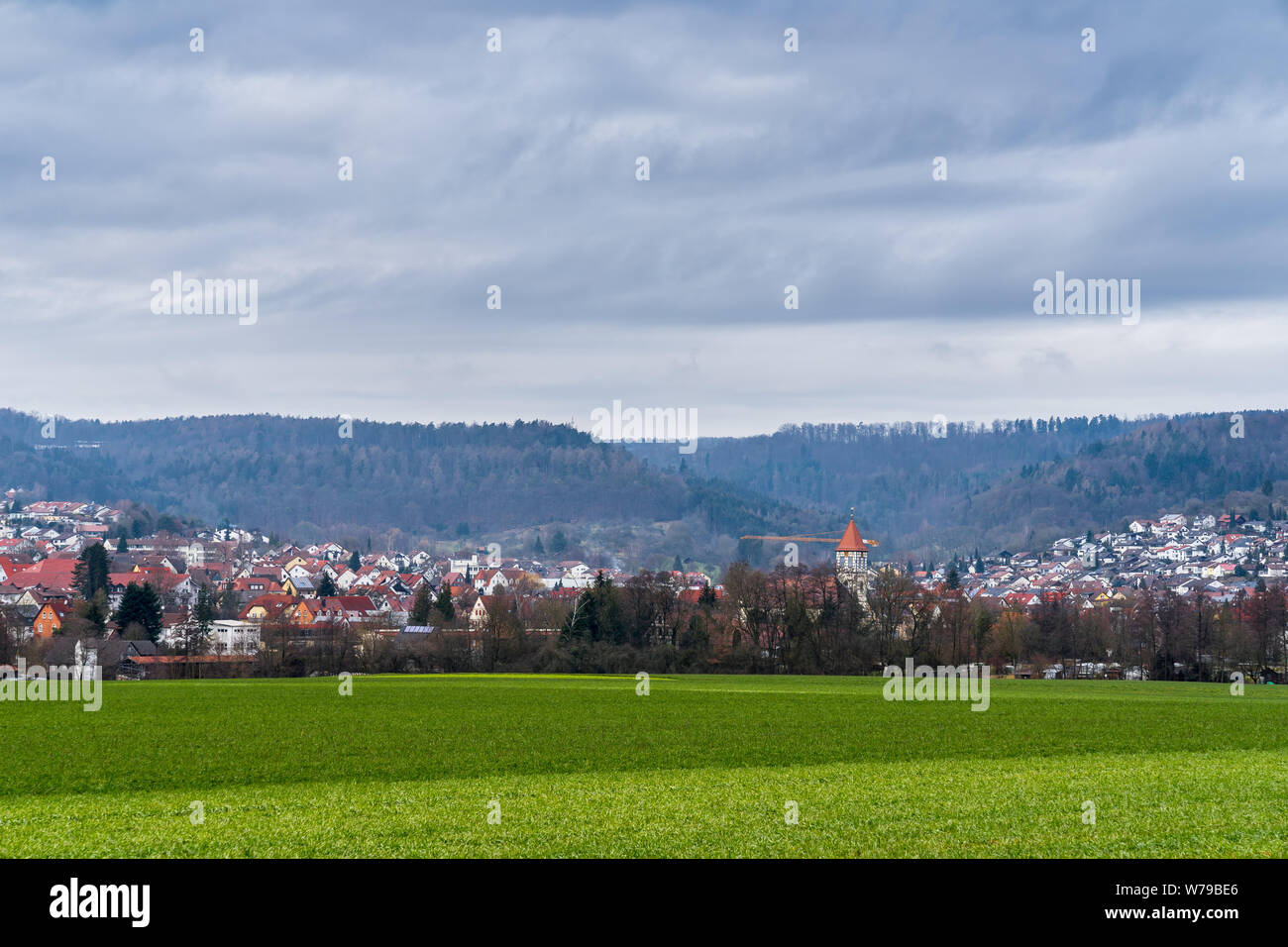 Germany, dreamy houses of village rudersberg behind green pasture Stock Photo