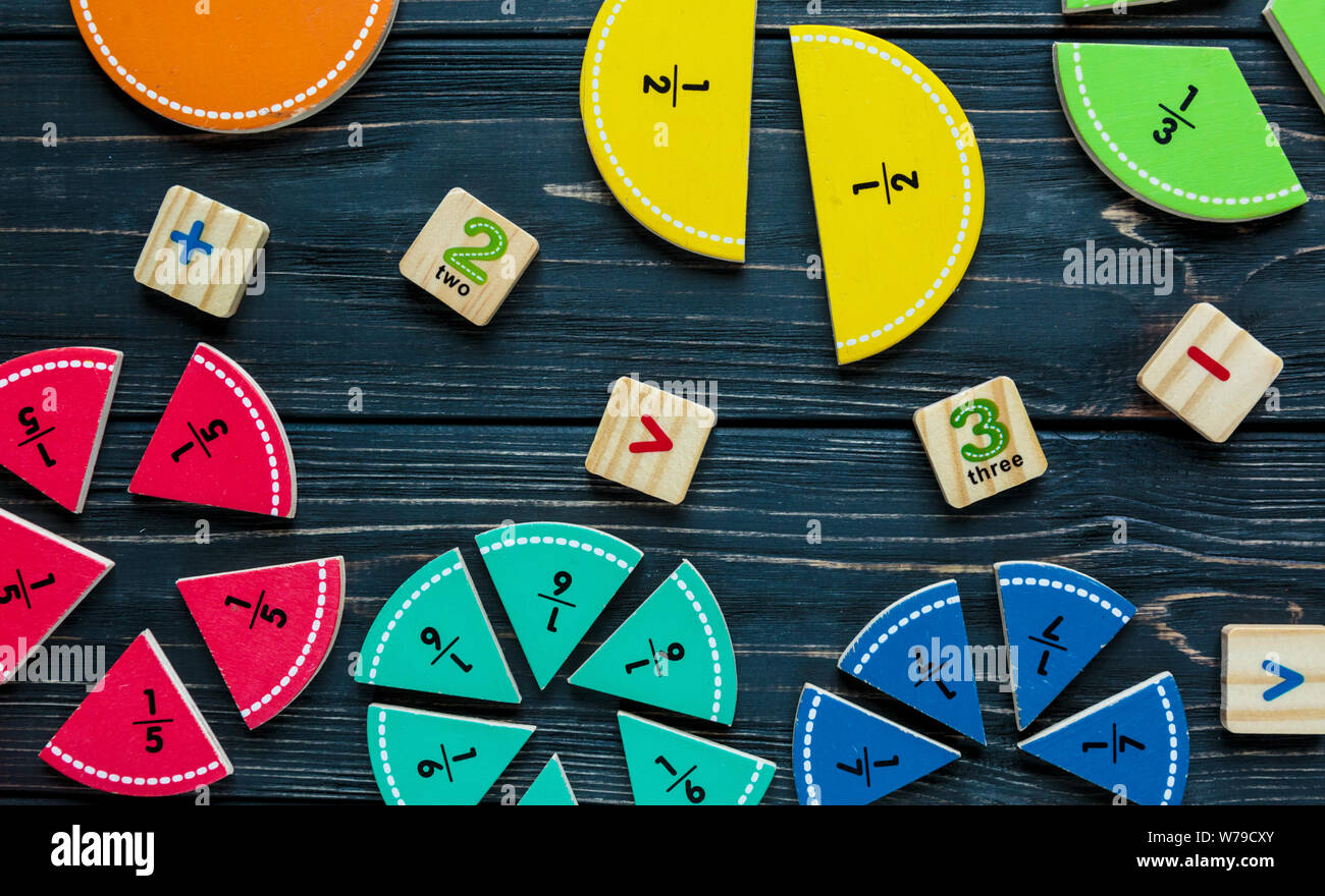 Creative Сolorful math fractions on dark background. Interesting funny math for kids. Education, back to school concept. Geometry and mathematics mate Stock Photo