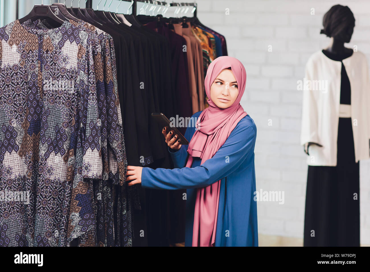 Arab woman in traditional Muslim clothes buys a new dress in an Oriental  store Stock Photo - Alamy