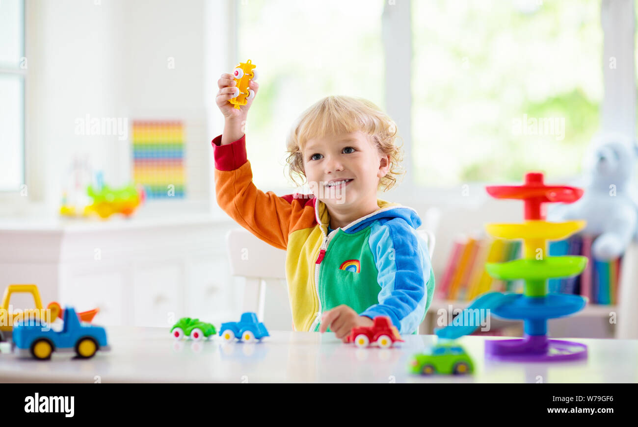 Little Boy Playing Toy Cars Young Kid With Colorful Educational