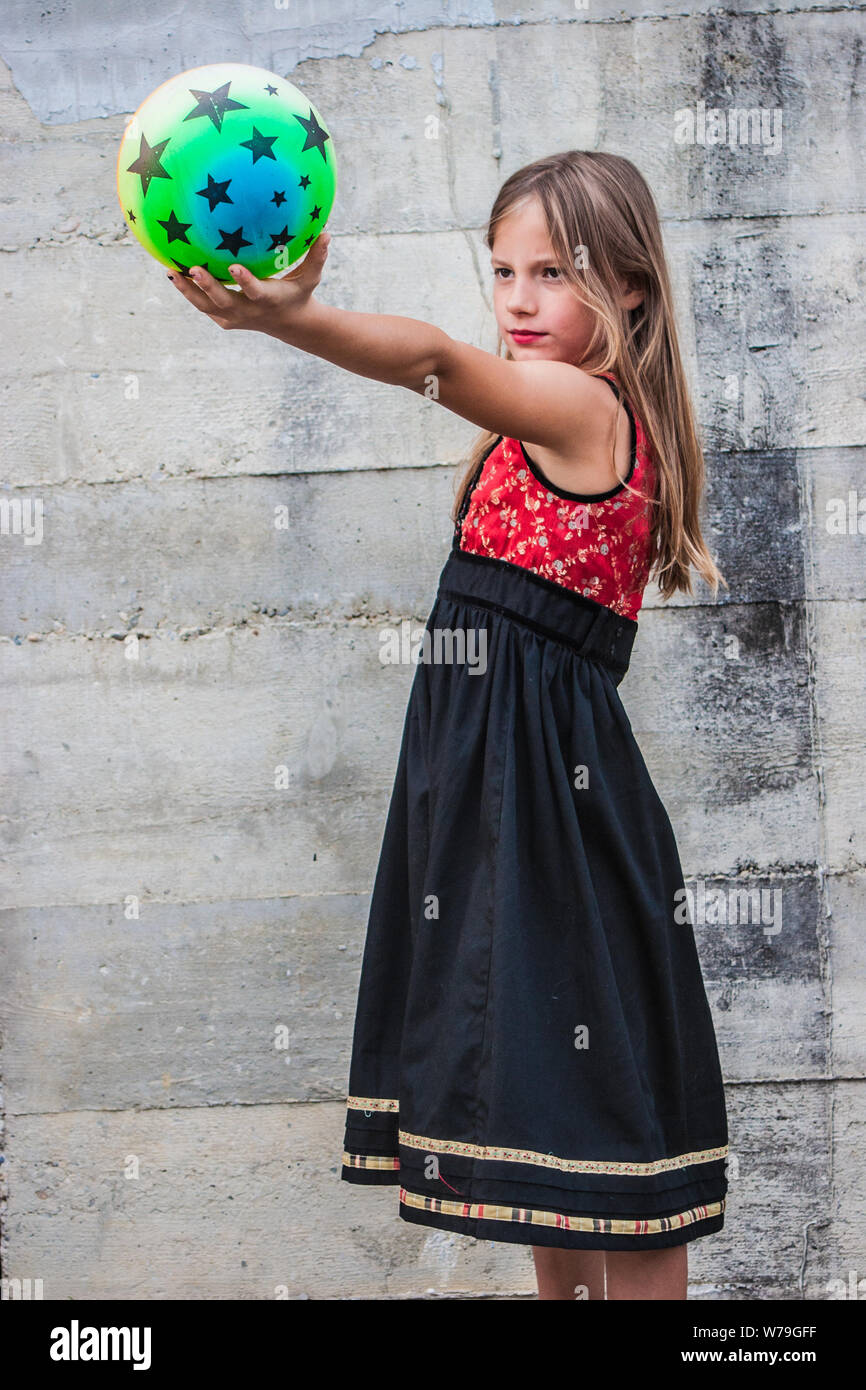 Beautiful young girl holding a toy ball Stock Photo